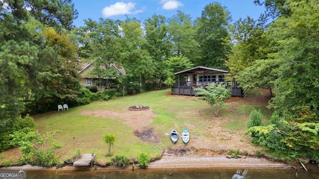 view of yard featuring a gazebo, a water view, and a fire pit