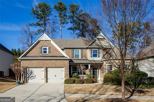 view of front of home with a garage and cooling unit