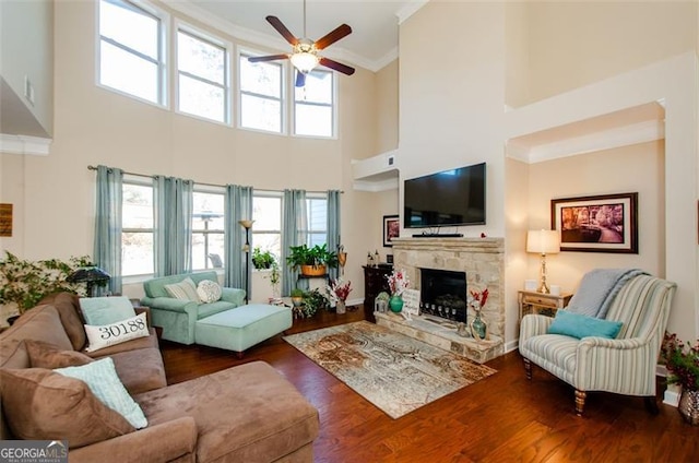 living room featuring crown molding, plenty of natural light, and dark hardwood / wood-style flooring