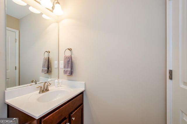 bathroom featuring vanity and a chandelier