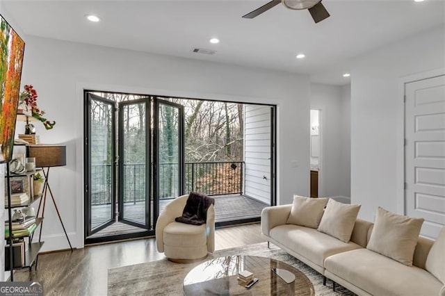 living room featuring hardwood / wood-style flooring and ceiling fan