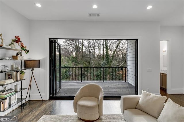 sitting room with dark wood-type flooring