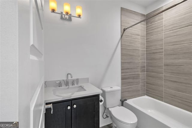 full bathroom featuring tiled shower / bath combo, vanity, and toilet