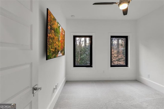 spare room featuring ceiling fan and carpet flooring