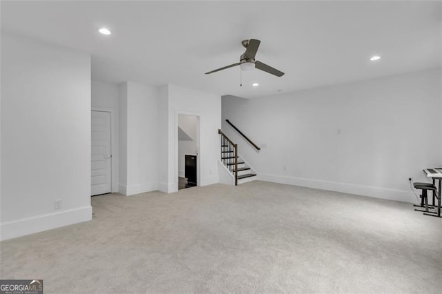 unfurnished living room with ceiling fan and light colored carpet