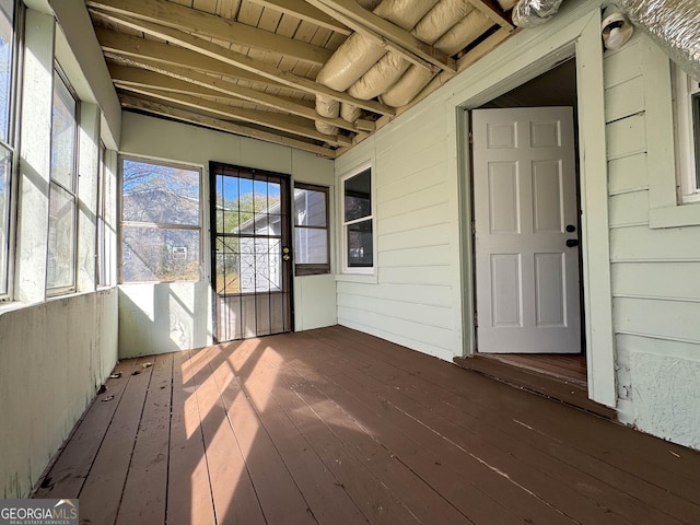 unfurnished sunroom featuring beam ceiling and wooden ceiling