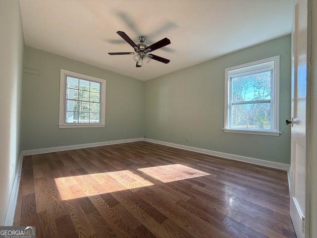 unfurnished room featuring ceiling fan, plenty of natural light, and dark hardwood / wood-style flooring