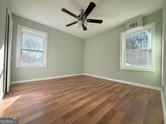 unfurnished room with hardwood / wood-style flooring and ceiling fan