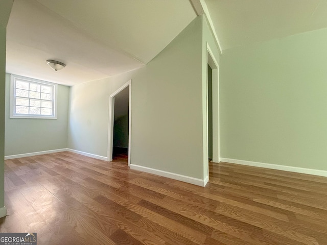 empty room with hardwood / wood-style flooring