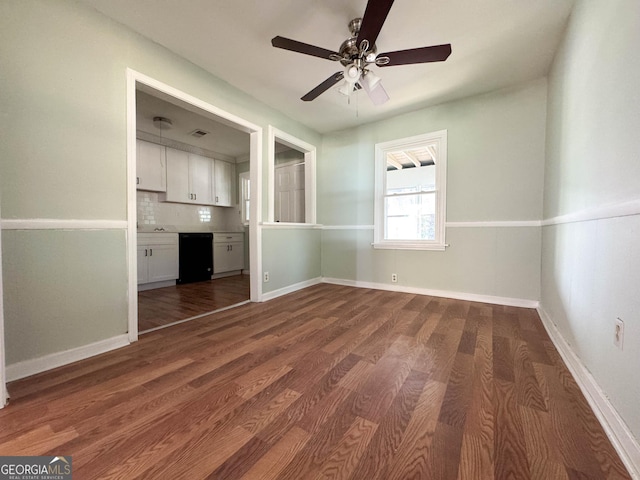 interior space featuring ceiling fan and dark hardwood / wood-style floors