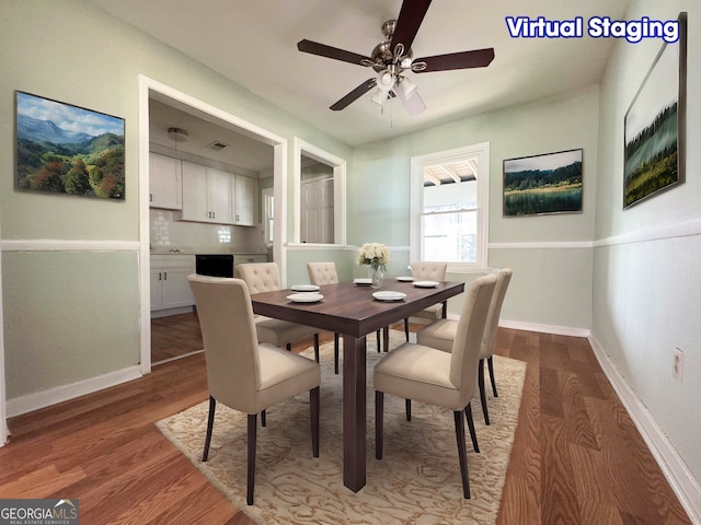 dining space with ceiling fan and wood-type flooring