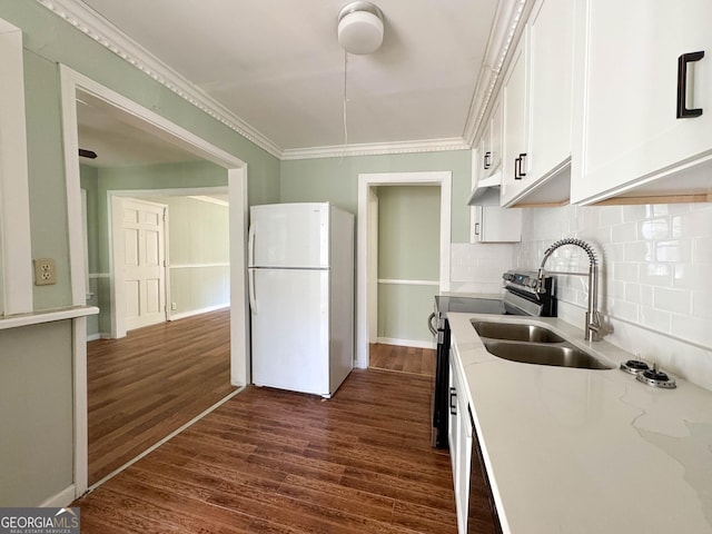 kitchen featuring white refrigerator, ornamental molding, dark hardwood / wood-style floors, light stone countertops, and white cabinets