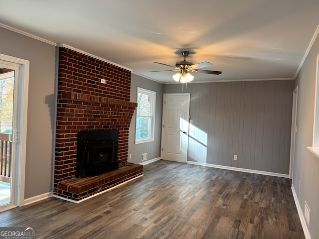 unfurnished living room featuring ornamental molding, dark wood-type flooring, ceiling fan, and a fireplace