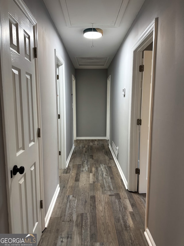 hallway with dark hardwood / wood-style floors