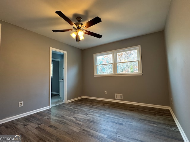 unfurnished bedroom with connected bathroom, dark hardwood / wood-style floors, and ceiling fan