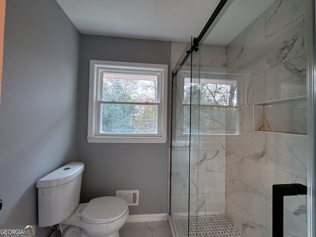 bathroom featuring an enclosed shower and toilet