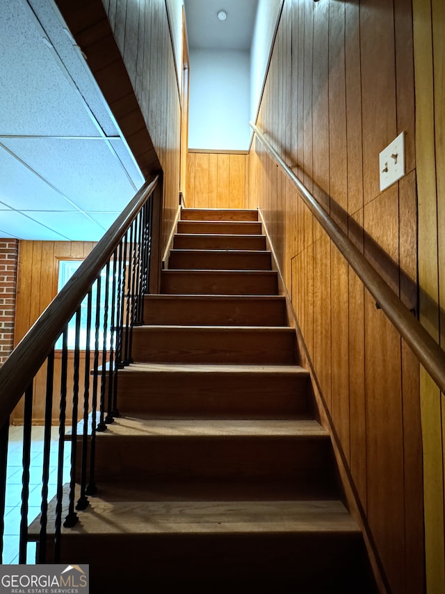 stairs featuring wooden walls