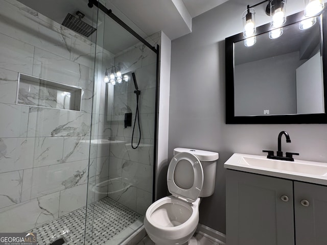 bathroom featuring vanity, toilet, and a shower with shower door