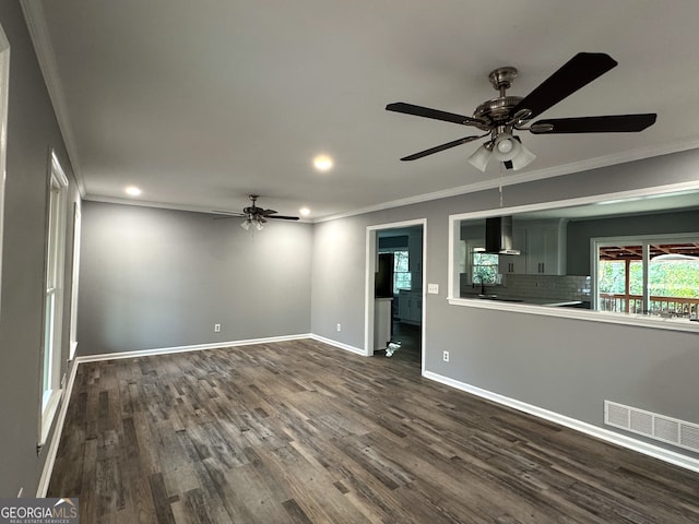 unfurnished living room with ornamental molding, dark hardwood / wood-style floors, sink, and ceiling fan