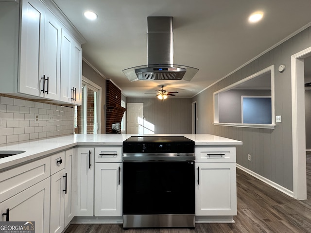 kitchen featuring range with electric stovetop, ornamental molding, white cabinets, and island exhaust hood