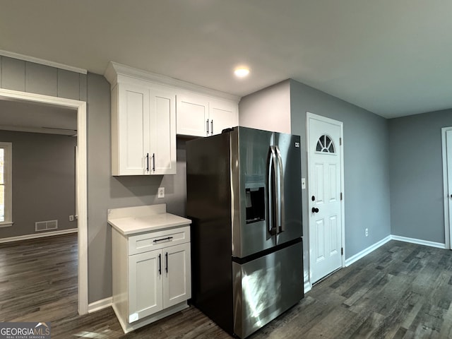 kitchen featuring stainless steel refrigerator with ice dispenser, white cabinetry, and dark wood-type flooring