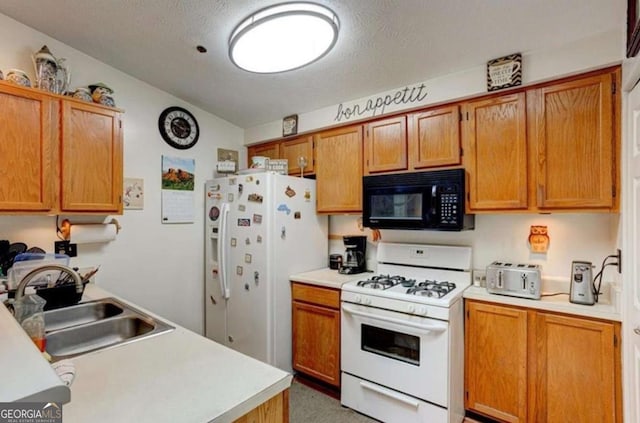 kitchen with lofted ceiling, sink, white appliances, and a textured ceiling