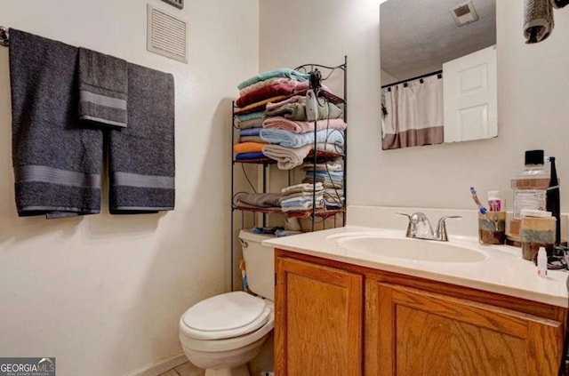 bathroom with vanity and toilet