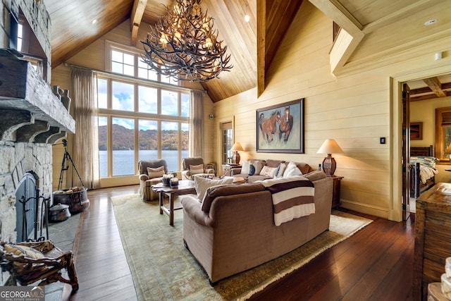 living room with a fireplace, hardwood / wood-style flooring, wood ceiling, a water view, and beam ceiling