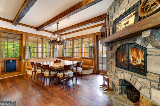 dining space with beamed ceiling, dark wood-type flooring, an inviting chandelier, and a fireplace