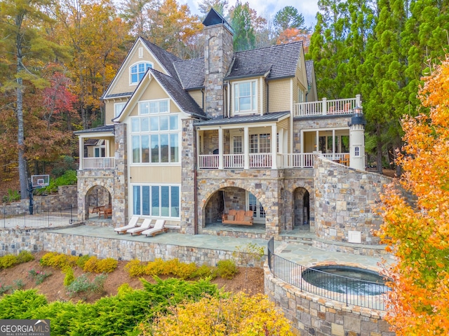 back of property with a patio and a balcony