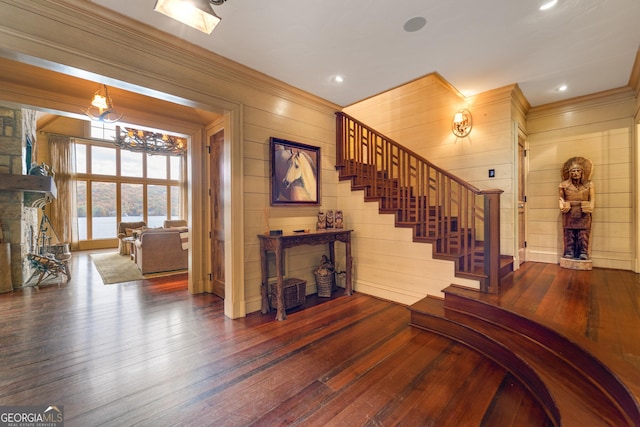 stairs with hardwood / wood-style flooring and ornamental molding