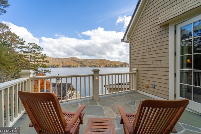 balcony with a water and mountain view