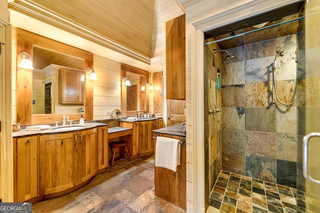 bathroom with vanity and a tile shower