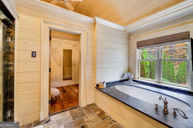 bathroom with crown molding, a bathtub, wooden walls, and wood ceiling