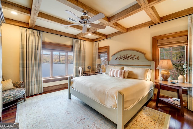 bedroom with a water view, coffered ceiling, dark wood-type flooring, and beam ceiling