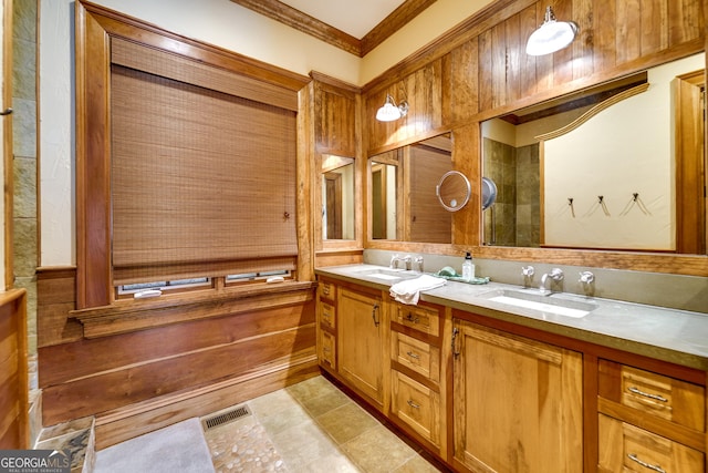 bathroom with crown molding and vanity