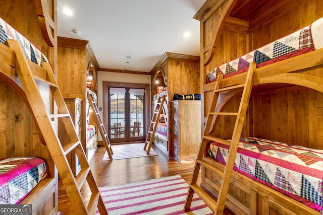 bedroom with french doors, crown molding, hardwood / wood-style floors, and access to outside