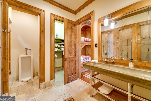 bathroom with ornamental molding and walk in shower