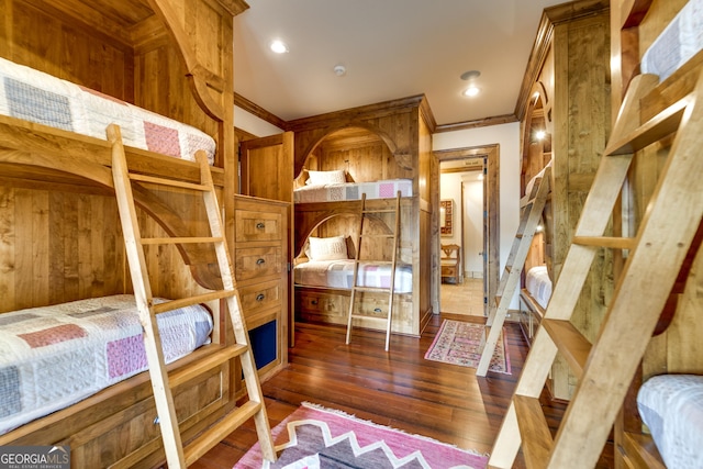 bedroom with dark hardwood / wood-style flooring and crown molding