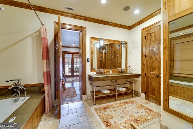 bathroom with sink, crown molding, and a shower with shower curtain