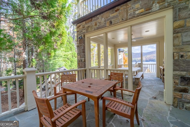 view of patio featuring ceiling fan and a mountain view