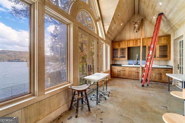 sunroom / solarium featuring a water view, wooden ceiling, and lofted ceiling