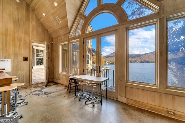 sunroom with lofted ceiling, plenty of natural light, a water and mountain view, and wooden ceiling