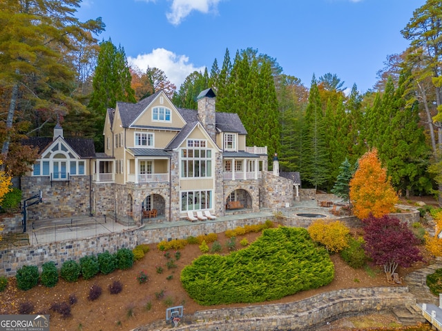 rear view of property with a balcony