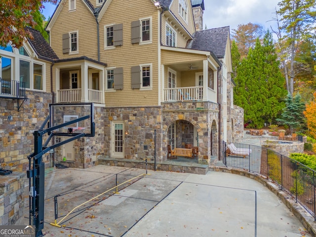 rear view of property with basketball court