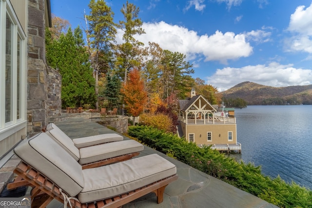 view of patio with a water and mountain view