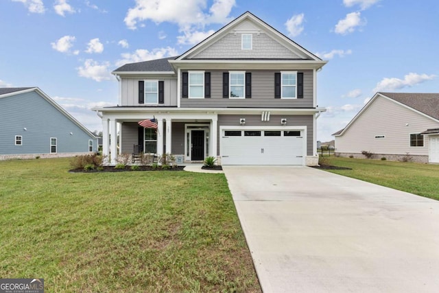 view of front of property featuring a garage, a front yard, and a porch