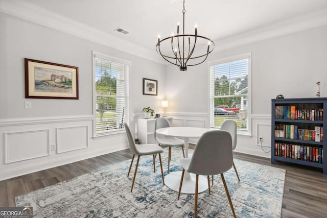 dining room featuring a wealth of natural light, ornamental molding, and a chandelier