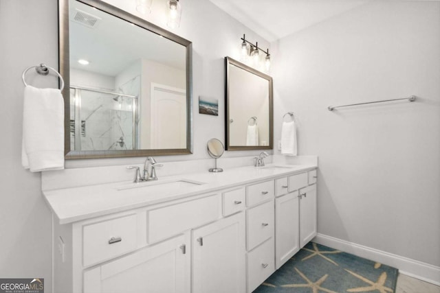 bathroom with a shower with door and vanity