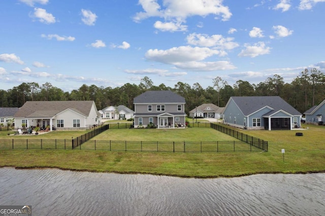 exterior space featuring a lawn and a water view